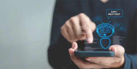 Hands holding a smartphone with a chatbot icon offering help